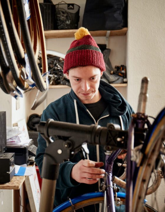 a-young-man-working-in-a-cycle-shop-repairing-a-b-2022-03-04-02-20-22-utc