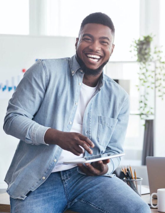 cheerful-black-employee-using-digital-tablet-in-of-2022-12-16-07-21-02-utc