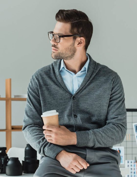 handsome-male-photographer-with-coffee-working-in-2022-12-16-18-18-50-utc