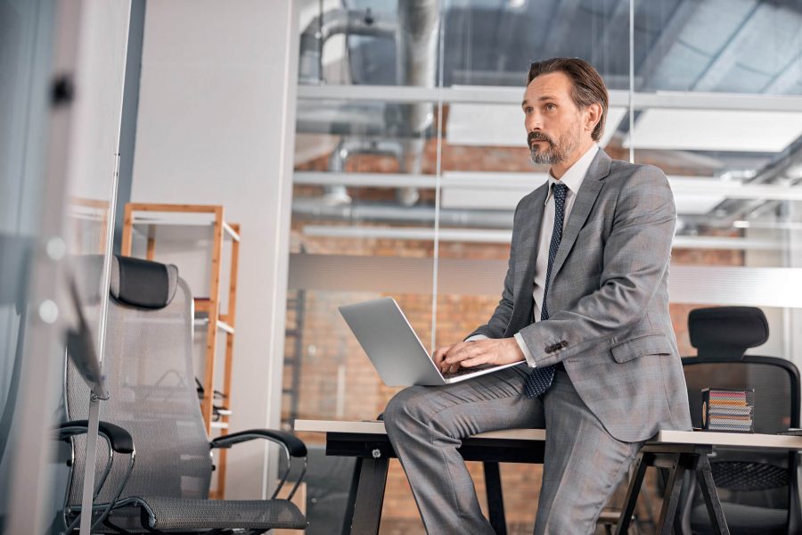 handsome-businessman-using-modern-laptop-at-work-2021-09-03-14-18-33-utc