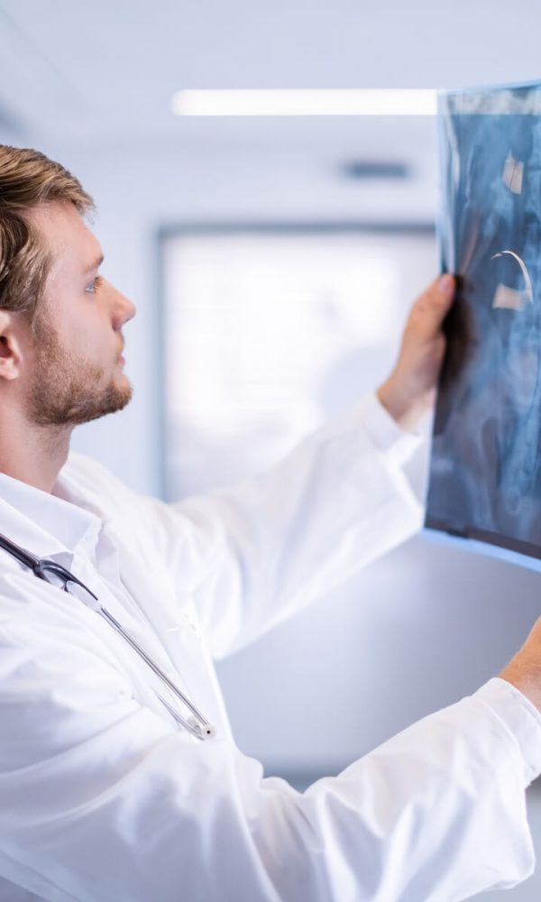 male-doctor-examining-x-ray-in-corridor-2023-11-27-05-07-50-utc_crop
