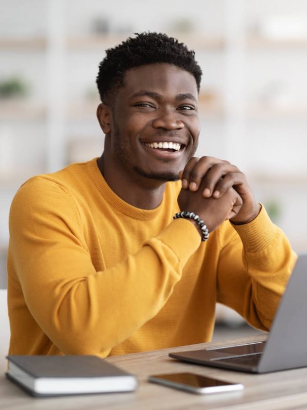 black-man-freelancer-sitting-at-workdesk-at-home-2022-12-16-08-26-37-utc