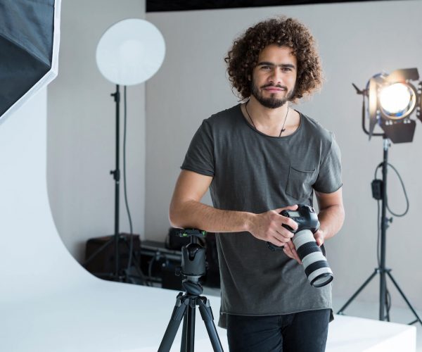 happy-male-photographer-standing-in-studio-2021-08-28-17-24-05-utc